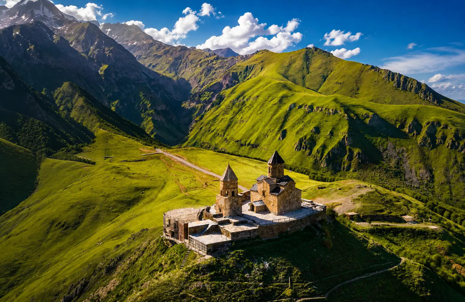 Gergeti Trinity Church in Kazbegi with Caucasus Mountains — Georgia travel guide