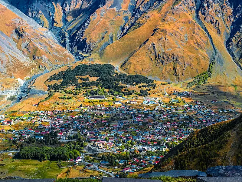 Stepantsminda village with Caucasus Mountains — Kazbegi travel guide